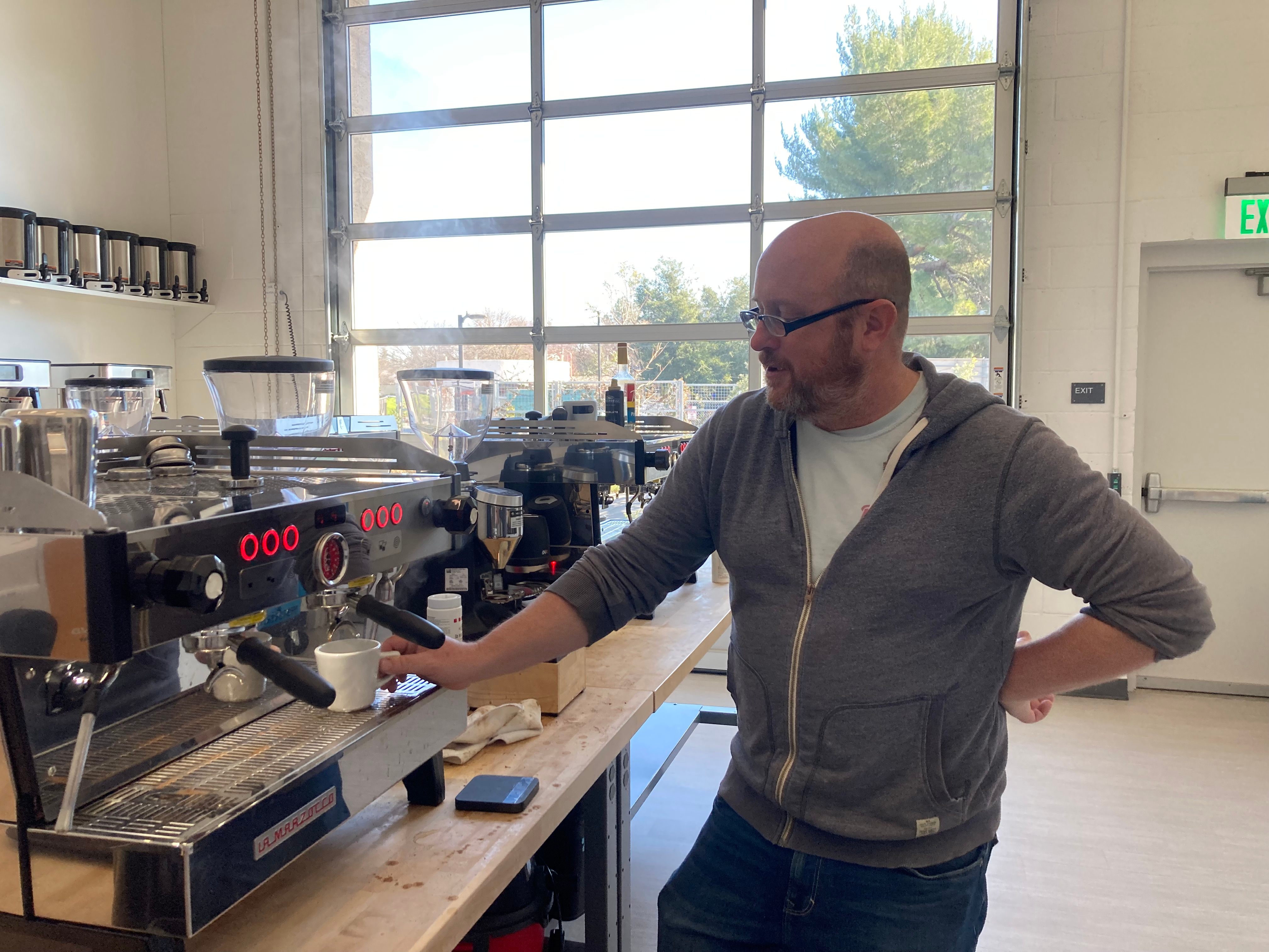 A man making an espresso in a coffee lab