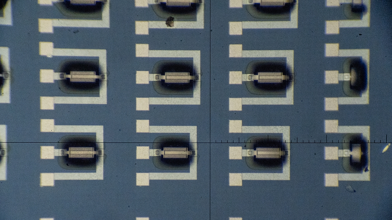 Microscopic view of nanoscale detecors, which look like black and white lines and squares in a geometric pattern on a blue background