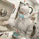 Researchers in a lab wearing PPE 
